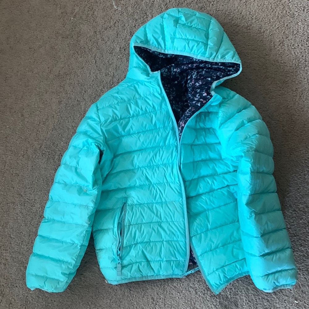 Blue puffer jacket with different colored print on the inside